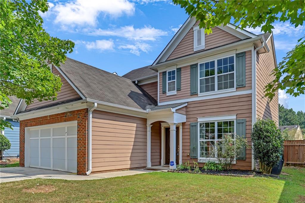 Beautiful 3BR/2.5BA home in Lawrenceville with an open floor plan and hand-scraped hardwoods on the main. Family room features a cozy fireplace with shiplap accent that's open to the spacious kitchen with stained cabinets, granite counters, and stainless steel appliances. Upstairs offers a huge owner's suite with a walk-in closet, double vanity, shower, and a garden tub, plus two additional bedrooms. Enjoy the covered patio, level fenced yard, and a prime location near shopping, highways, and top schools.