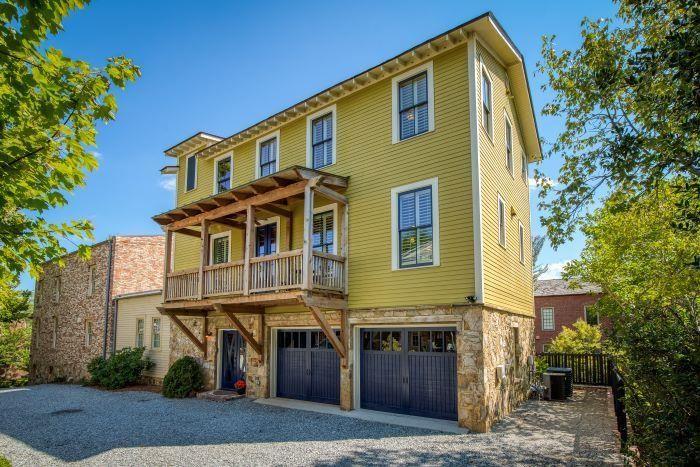 Lew Oliver designed townhome in the heart of the Roswell Historic Mill District! Beautifully crafted and freshly painted with soaring ceilings, hardwood floors, and windows on all 4 sides! True chef’s kitchen with stainless steel appliances, pull-out shelving, and custom island dining! Family room with fireplace and 2 covered balconies offer multiple entertaining possibilities on this floor alone! Huge, wrap-around private patio on the ground floor offers even more! Large, light-filled primary bedroom has 4 windows and a walk-in closet! Fabulous primary bath features 2 vanities, oversized shower, and large soaking tub! Secondary bedrooms both have ensuite baths as well! Spacious elevator serves all 3 floors! New roof was just installed! With its entrance on Mill Street, this small, private 4-townhome complex is literally down the street from the Roswell Mill, the Covered Bridge, and the Vickery Creek Park Trail entrance. Souper Jenny, Moxie Burger, The Mill Restaurant, and Roswell Square are all in the immediate vicinity, with Canton Street, City Hall, and the upcoming new Hill Street development just a short walk away.