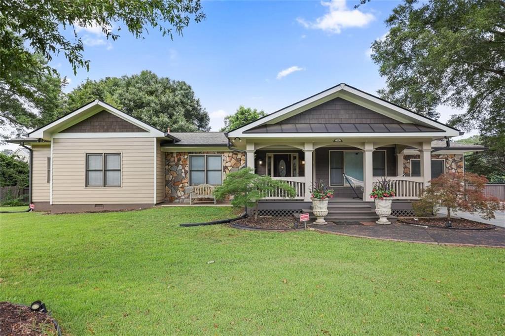 Welcome to 1665 Cunningham Rd SW, Marietta, GA 30008! A beautifully maintained home that combines space, privacy, and convenience in one of Marietta’s most accessible locations! New Roof! New Gutters! New HVAC System! As you walk right in, you'll see the Formal Entry and Formal Dining Room, ideal for Family Gatherings. Walk into the Spacious Kitchen with breakfast bar and Custom Built Beverage and Buffet Cabinets. Step inside to a spacious Primary Suite featuring stunning high ceilings that create an airy and relaxing atmosphere. The Primary Bathroom offers double vanities, a soaking tub, and a separate shower, providing a spa-like retreat. Two additional Bedrooms are connected by a thoughtfully designed Jack-and-Jill bathroom, each with its own vanity and a shared shower, ideal for family living or hosting guests. Terrace Level includes 2 Bonus Rooms/Flex Spaces for guest, office space or media room, cozy living room and kitchenette. Outdoors, enjoy a massive, fully fenced backyard that is ideal for pets, play, weekend gatherings, or future expansions. The double driveway with gated access adds security and provides ample parking. Just minutes from grocery stores, popular dining options, and the vibrant Marietta Square, this home delivers exceptional convenience with a cozy, suburban charm. Don't miss this beautifully designed home in a prime Marietta location where comfort, privacy, and functionality come together in perfect harmony. Schedule your appointment Today. This Marietta Gem won't last long!