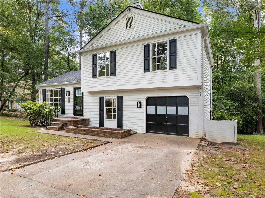 So much is NEW in this charming, recently renovated home, just a short walk from downtown Norcross with its adorable shops, dining, parks, and year-round events! New interior paint, new flooring, and upgraded design throughout! New roof and gutters installed in 2021. Enjoy the cathedral ceiling and open floorplan in the main living area with a spacious living room, dining room and bright, beautifully upgraded kitchen with newer stainless steel appliances, solid-surface countertops and handy island. Refrigerator stays! Find the owner’s oasis upstairs with a generous primary bedroom with completely modern, renovated full bathroom featuring an oversized tile shower with frameless glass door, large vanity with storage and a high-end lighted mirror that lets you pick the light style. Upgraded Elfa closet systems in primary and one secondary bedroom. Two additional bedrooms share the hall bath, also fully renovated. Home offers additional living space on the lower level, with a large room with built-in brick fireplace that is an ideal space for a den, office, playroom or workout room. Relax on the screened porch while enjoying the peaceful, park-like backyard retreat. Oversized one-car garage offers storage options as well as parking. No HOA! Easy access to I-85, making your commute quick and easy. Nearby Peachtree Corners offers additional shopping, dining, and recreation. This home’s incredible location along with its modern comfort combined with classic charm makes it a rare find! Come see it today!