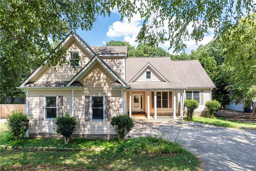 Excellent opportunity to build equity here in the heart of Kings Ridge Estate with this spacious 4 bedroom, 2 bath home on over an acre of land in prime Woodstock location. Quaint front patio entry opens to gracious foyer lending itself into the vaulted great room with fireplace and Kitchen with breakfast area. Master suite enjoys trey ceiling, french doors opening to vaulted bath with double vanities, separate shower and soaking bath and walk in closets. Brand new deck overlooks well-kept flat backyard. New features include new deck, updated septic tank pump and electrical system and HVAC servicing. Plenty of room to finish out the full daylight terrace level basement with exterior & interior access. 2 carage garage and additional opportunity to create more built-in storage. Home is privately set back away from the road inviting you to enjoy the privacy the lot has to offer. Close proximity to shopping, restaurants, Lake Alatoona, I-575, and more!