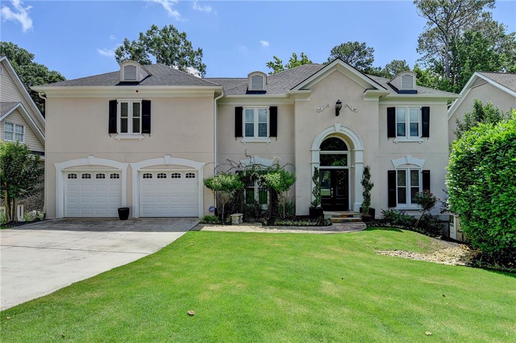 Welcome to your dream home in the heart of Johns Creek—recently named the #1 Best Place to Live in the U.S. This beautifully maintained 6-bedroom, 5-bathroom home offers the perfect blend of elegance, comfort, and convenience, nestled in one of North Atlanta’s most sought-after communities. From the moment you arrive, the impressive curb appeal and brand-new double entry doors set the tone for what’s inside. Step into a grand split-staircase foyer featuring newly refinished gleaming hardwood floors, cathedral ceilings, crown molding, and elegant wainscoting. The spacious formal dining room is ideal for hosting large gatherings, while the versatile living room can be used as a formal sitting area, study, or enclosed home office. The open-concept back half of the main level is truly the heart of the home. A modern kitchen with breakfast area flows seamlessly into the great room with vaulted ceilings and a cozy fireplace—perfect for everyday living or entertaining. Just off the breakfast room, enjoy morning coffee or evening sunsets in your screened-in porch overlooking the private, wooded backyard. A guest bedroom with full bath on the main level offers flexibility for multi-generational living or a second office. Upstairs, the oversized owner’s suite is a private retreat with double doors, a spa-inspired bath with soaking tub, dual vanities, and a massive walk-in closet with built-ins that doubles as a dressing room. Three additional bedrooms upstairs include one en-suite and two sharing a Jack-and-Jill bath. The fully finished terrace level provides unlimited possibilities with four flexible areas ideal for a home gym, media room, playroom, music studio, or workshop. More Key Features included: NEW triple-pane energy-efficient windows throughout (lifetime warranty), Planation Shutters, Brand new water heater + expansion tank, New interior Sherwin-Williams paint, updated lighting in foyer and dining room, New carpet upstairs, Professionally landscaped front yard with French drains, Backyard features hardscaped patio and firepit, Newly stained full-length deck, Refrigerator, Washer & Dryer included, Dual staircases (front and rear access). Enjoy double the amenities—two swimming pools, two clubhouses, two playgrounds, 12 tennis courts, pickleball courts, pro shop, basketball court, soccer field, lake, nature trails, and year-round social events for all ages! Located just minutes from top restaurants, shopping, parks, and entertainment—this is a rare opportunity to own a move-in ready home in one of the most vibrant and desirable communities in Metro Atlanta. This home truly has it all—space, location, lifestyle. Schedule your private showing today!