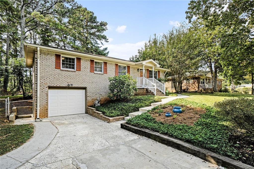 Beautiful 3 Bedroom BRICK-4-SIDED Home Conveniently Located to All MARIETTA, SMYRNA, WEST COBB, and SOUTH COBB has to Offer!!! WELL-LOVED & Suited for a variety of buyers, this home boasts Newly RE-FINISHED REAL HARDWOOD FLOORS, FRESH PAINT w/TASTEFUL MODERN COLORS, Versatile SPACES, Expansive ENTERTAINING OUTDOOR SPACE, Enclosed GARAGE PARKING, & Spacious UNFINISHED BASEMENT! Upon entry, this home offers a large formal FIRESIDE living area transitioning to a FLEXIBLE secondary LIVING/DINING AREA just off U-shaped Kitchen w/Lots of COUNTER & CABINET SPACE including SERVING BUFFET and WALK-OUT ACCESS to GRILLING & ENTERTAINING BACKYARD! 3 Bedrooms offer room for everyone w/Additional BASEMENT for RECREATION/STORAGE! DREAMY OUTDOOR SPACE includes FENCED YARD for Furry Friends to run, GARDENING SPACES w/Plenty of Sun, SPACIOUS CONCRETE PATIO for Firepit or Basketball Goal, or ENTERTAINING!! Convenient to SHOPPING/DINING in ALL DIRECTIONS & WELLSTAR COBB HOSPITAL/Medical Offices. Minutes to Downtown Marietta, Smyrna, THE BATTERY, CUMBERLAND, I-285, I-20, & Atlanta Hartsfield AIRPORT! Located in SOUTH COBB HIGH SCHOOL DISTRICT. DON'T MISS THIS ONE!!
