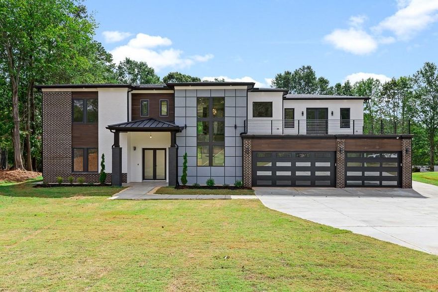 WILL BE READY MID AUGUST! Luxury abounds in this one-of-a-kind modern contemporary new construction home located in the desirable BUFORD CITY SCHOOL SYSTEM! Marvel at the extravagant floor to ceiling upgrades everywhere you look. The grand two-story foyer and family Room w/ endless custom windows boasts natural light that create an unparalleled feeling of indoor/outdoor living. The gourmet kitchen awards you everything you could imagine for the ultimate culinary experience, and every inch of this OVER 6,000 SF luxurious home feels spacious and open. The two primary suites were carefully designed, one on each level, and the primary bath retreats are sure to make you feel like you are living at the Spa. Relax and bask in the sun on the lavish upstairs balcony w/ expansive and stunning views. Custom features EVERYWHERE YOU LOOK! Every feature is the epitome of the finer things in life. Spoil yourself upstairs with a junior master suite, open loft area and an abstract sculptured fireplace. The covered patio spanning the width of the home is sure to impress you with a vision of the perfect entertaining experience. Come see this IMPRESSIVE HOME for yourself! You will be in awe. Do not miss your chance to reside in the #1 School System in GA, Buford City Schools. Live in the utmost of a lavish and luxury lifestyle. Centrally located very close to shops, restaurants, Buford City Schools, I-85, I-985, Mall of Georgia and Lake Lanier. Completion date June/July 2025. Rendering and stock photos used of a finished home by this custom builder.
