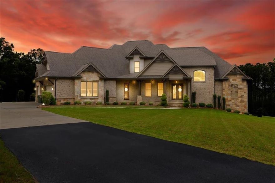 Welcome to 5460 Emmett Still Road, a breathtaking estate that blends sophistication, comfort, and endless possibilities. Nestled on over thirteen private acres in one of Loganville’s top school districts, it is a stunning residence that is a true retreat for those who value elegance, privacy, and lifestyle. This three-level masterpiece offers six spacious bedrooms, six full baths, and two half baths, with each bedroom featuring its own private en-suite. Upon entering, enjoy the grand foyer coupled with open access to the living and dining room both warmed by the fireplace. Whether preparing meals for your family or entertaining guests, this space is as functional as it is beautiful. At the heart of the home, the gourmet kitchen showcases suede granite countertops, a butler’s pantry, built-in refrigerator, temperature-controlled wine cellar, massive island, breakfast nook and a view to the great room equipped with a coffer ceiling, built-in shelving and a fireplace. 

The primary suite located on the main level, is a true sanctuary, with access to a serene deck and featuring its own fireplace. The spa-inspired bathroom feels like a five-star retreat, complete with his-and-her vanities on opposite sides, dual walk-in closets with custom storage, an oversized floor-to-ceiling tiled shower with glass entry, a freestanding soaking tub, and premium flooring.

The finished terrace level offers more than three thousand square feet of additional living space, thoughtfully designed for guests, entertaining, or multi-generational living. Here you will find a secondary master suite with an attached luxury bath, full kitchen, media room, rejuvenating sauna, washer and dryer connections, and direct elevator access. This level opens onto a covered patio that overlooks the sparkling pool, seamlessly blending indoor comfort with outdoor resort-style amenities.

Outdoors, every detail is crafted for luxury living. The property features a pool with an adjoining Jacuzzi, custom fire pit for evenings under the stars, and an oversized pavilion pre-wired for a full outdoor kitchen and bathroom. Parking and storage are equally impressive with a three-car garage, along with a separate oversized garage designed to accommodate large vehicles or recreational equipment. Top ranked schools with convenient access to Cedar Lake Golf Club and T.W Briscoe Park. 

Whether hosting grand gatherings, relaxing in the spa-like amenities, or creating the lifestyle of your dreams, this residence delivers it all.