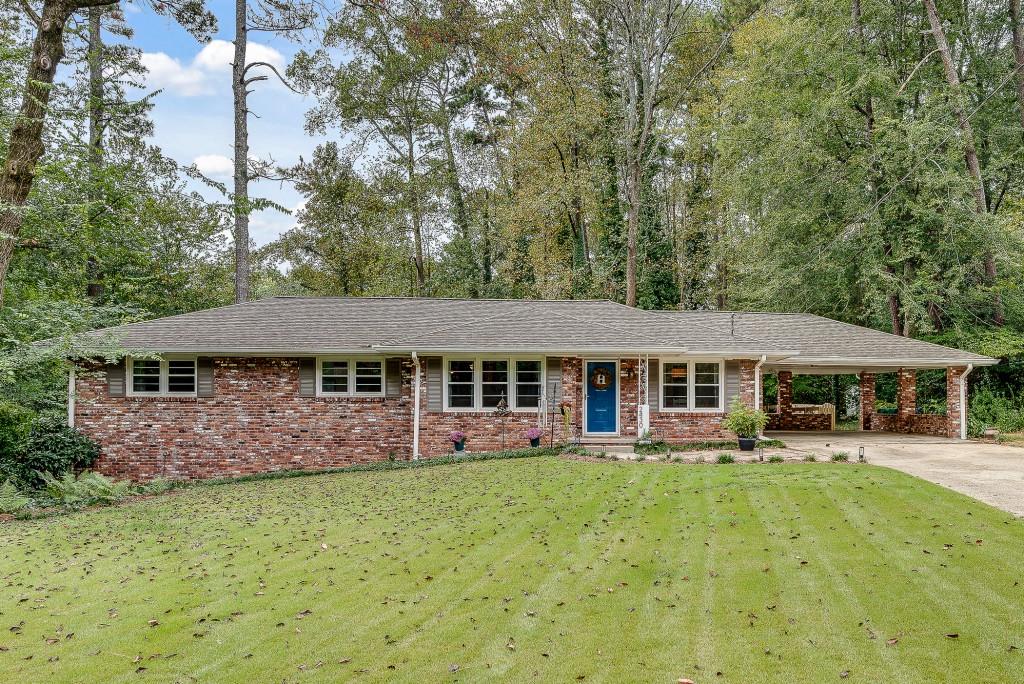 Sunny and bright 5 bed/3 bath, impeccably maintained and beautifully updated brick ranch on a quiet, friendly cul de sac street in Lakeside - this one really checks all of the boxes! Tucked away on lovely landscaped yard, in a park- like setting, this warm and happy home features abundant natural light, creating an airy, open feel. A large living room and dining room leads to a renovated kitchen and flows to a versatile sunroom overlooking an expansive, private and playable yard, a true natures lovers dream. Rounding out the main level is the spacious primary bedroom with full bath and oversized closet, plus two ample secondary bedrooms and spacious bath. Light-filled, finished terrace level with bedroom, bath and huge family room offers additional workshop/storage area--- plenty of room for everyone and the flexible spaces are ideal for an art or music studio or home gym. Gorgeous patio with a firepit, two car carport, newer roof, hardwood floors throughout and so much more make this one very special place to call home. You'll love the parade of people and their pets as they walk, jog, stroll and cycle in this leafy green neighborhood. Top rated public and private schools, parks, playgrounds & pools abound. Very easy access to the new CHOA hospital, Emory/CDC, I-85, shopping, great restaurants, new, multi use path & much more.
