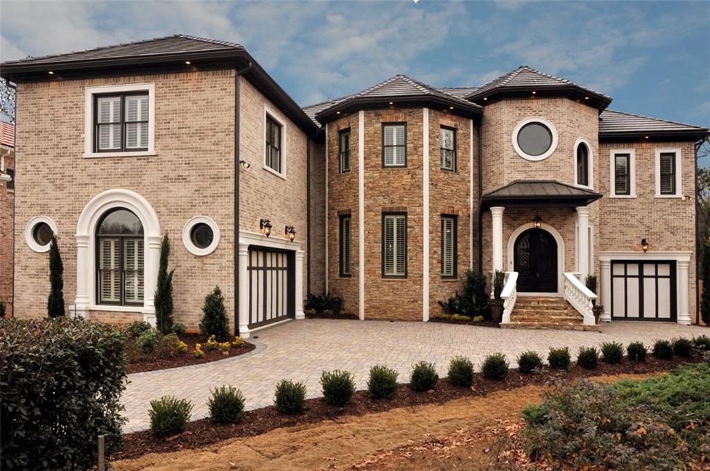 Exceptional "Masterpiece" design by Premier Builder, Olympia Homes. Private gated estate community in the heart of E. Cobb. Walton High School. Dramatic interior design features sweeping circular staircase, hand sculpture concrete columns and 2 story fireplace. Secluded master retreat features radius sitting room w/fpls., spa bath & huge California his/her closets.Private guest suite on main. Fabulious gourmet main kitchen, plus ethnic kitchen. All bedrooms have full baths and walk-in closets. Exterior has screen porch & tile deck. Concret slate tile roof. Finished Bsmt