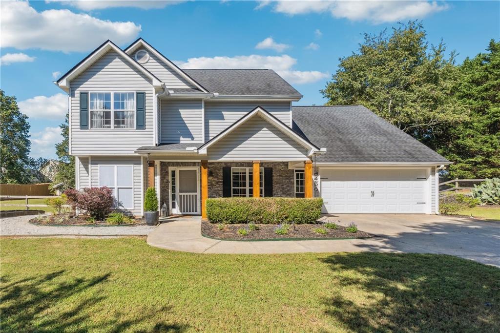 Welcome to this beautifully updated, move-in-ready 4-bedroom, 2.5-bathroom home that combines convenience with peaceful country charm. Located just minutes from Hwy 400, Lake Lanier, shopping, dining, and parks, this property offers the perfect blend of secluded living and everyday accessibility—with NO HOA restrictions! Step inside to a bright, welcoming entry that opens into a spacious living room with a cozy wood-burning fireplace. The open-concept layout flows seamlessly into the updated kitchen, featuring granite countertops, a stylish new tile backsplash, stainless steel appliances, and a timeless color palette. BRAND-NEW FLOORING has been installed throughout the main level, which also includes a sunroom, a versatile bonus room (perfect as a formal dining space or additional living area), a renovated half bath, and a dedicated laundry space. Upstairs, the oversized primary suite offers tray ceilings and windows overlooking the park-like backyard, a newly renovated spa-like bathroom with a frameless glass shower, and a large walk-in closet with custom storage. Three additional spacious bedrooms, a full bath and LOTS of storage complete the upper level. Outside, you'll find a huge, fully fenced yard ideal for both relaxation and entertaining. Enjoy raised garden beds, a smokehouse, an outdoor shower, and a deck prepped for a hot tub. The large patio is perfect for outdoor dining or gathering with friends and family. All appliances are included, and with a newer roof and water heater, this is truly a low-maintenance home ready for its next chapter. Located in the highly sought-after East Forsyth High School district, this home checks every box—no HOA, stress-free ownership, a private country feel, and unbeatable convenience. As an added bonus: Preferred lender is offering a FREE appraisal and 0.25% rate reduction! Don’t miss your chance to own this turnkey gem—schedule your private showing today!