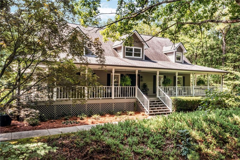 Set on two private acres, this thoughtfully designed home welcomes you with a classic wrap-around porch. With 3 bedrooms and 3.5 baths, each space showcases designer touches that elevate everyday living. The main level features hardwood floors, shiplap accents, custom oak built-ins, and elegant mouldings. The living room boasts a soaring cathedral ceiling open to the upper level and a cozy sun porch with views of the fenced backyard. The kitchen offers stone countertops, double pantries, and a bright breakfast nook that flows into an oversized dining room. The main-level primary suite includes a walk-in closet and a spacious bathroom with double vanities and a jetted tub.
Upstairs, two secondary bedrooms share a large flex space filled with natural light and views of the manicured yard. The finished lower level offers a media room with a projector screen and theater seating. You will also find a full bathroom, ample storage, and two versatile bonus rooms with their own entry, ideal for a home office, gym, or creative space.
Outdoors, enjoy raised garden beds, fruit trees, and a detached 2-car garage with a dedicated workspace. Additional features include RV or boat parking and an electric car charger. The architectural shingle roof is only 6 years old. With no HOA and a prime location just minutes from shopping, dining, LakePoint Park, Lake Allatoona, and I-75, this home truly offers it all.
SHOWINGS BEGIN FRIDAY AUGUST 8th.
