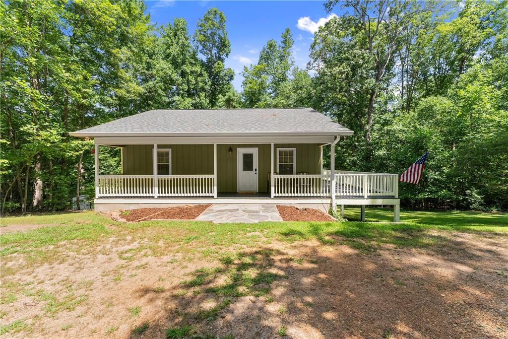 Nestled on 1.6 private acres in Dahlonega, this beautifully remodeled 2-bedroom, 2-bath home offers the perfect blend of rustic charm and modern comfort. New Roof in 2023, New Appliances and Wood Burning Stove in 2024! Thoughtfully updated throughout, the home features a warm, inviting interior with fresh finishes, a stylish kitchen, and updated bathrooms. The terrace level workshop with indoor and outdoor access is perfect for the serious (or not so serious) hobbyist. Whether you're relaxing on the spacious front porch, enjoying peaceful wooded views, or exploring the nearby wineries, trails, and historic downtown Dahlonega, this cozy retreat provides a serene lifestyle in North Georgia!