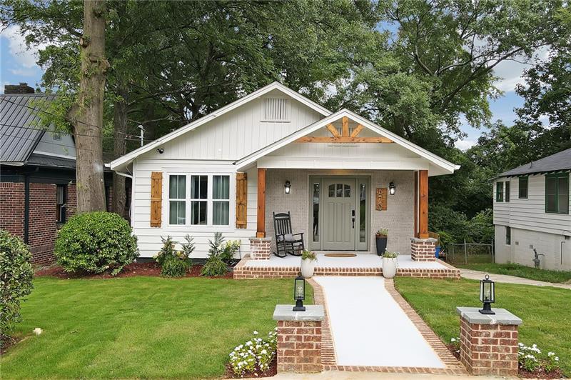 PRICED TO SELL! This revitalized 3-bedroom, 2.5-bath gem in Edgewood is where bohemian chic meets contemporary style. With a like-new construction feel, you'll enjoy all-new systems-plumbing, HVAC, flooring-a renovation curated with care + skill. This is more than a house; it's a whole vibe and you'll feel it! Let's start with a charming walkway with custom brick pillars + modern lanterns that leads you right up to the front door, welcoming you home. The driveway belongs to you so ample amount of parking too. Step inside, and you're greeted by a spacious, open-concept living area that just feels good. The living room is perfect for cozy nights, with an electric fireplace set against a stylish chevron accent wall + custom shelves that add just the right amount of character. But let's talk about the heart of the home-the kitchen. Custom cabinetry, sleek Samsung appliances, and a sophisticated pot filler above the gas range make it perfect for any chef. The expansive quartz-topped island? It's the ultimate spot for entertaining + culinary adventures. Picture friends gathering around, laughter filling the air, and you creating memories in this stunning space. Beyond the kitchen, you'll find the laundry nook + a half bath, all perfectly placed for convenience. And when you step outside, get ready to fall in love all over again. The spacious deck is perfect for hosting gatherings or just relaxing under the stars. Plus, the backyard is a true retreat with a newly added fire pit-ideal for cozy evenings with friends + family. The primary suite is a true sanctuary. It's been expanded to create a cozy, serene space, complete with a fireplace and rustic wood paneling that adds warmth and charm. The en-suite bathroom is all about luxury, with high-end finishes + thoughtful design that makes every day feel like a spa day. On the opposite side of the house, you'll find two additional bedrooms + a full bathroom, each blending quiet luxury with modern urban elements. Perfect for guests, family, or even a home office! And let's not forget-location, location, location! Living in Edgewood means you're in the heart of East Atlanta. Walk to Pure Quill Superette +El Tesoro for a bite to eat. Super close to East Atlanta Village, Kirkwood, parks, restaurants & shopping.