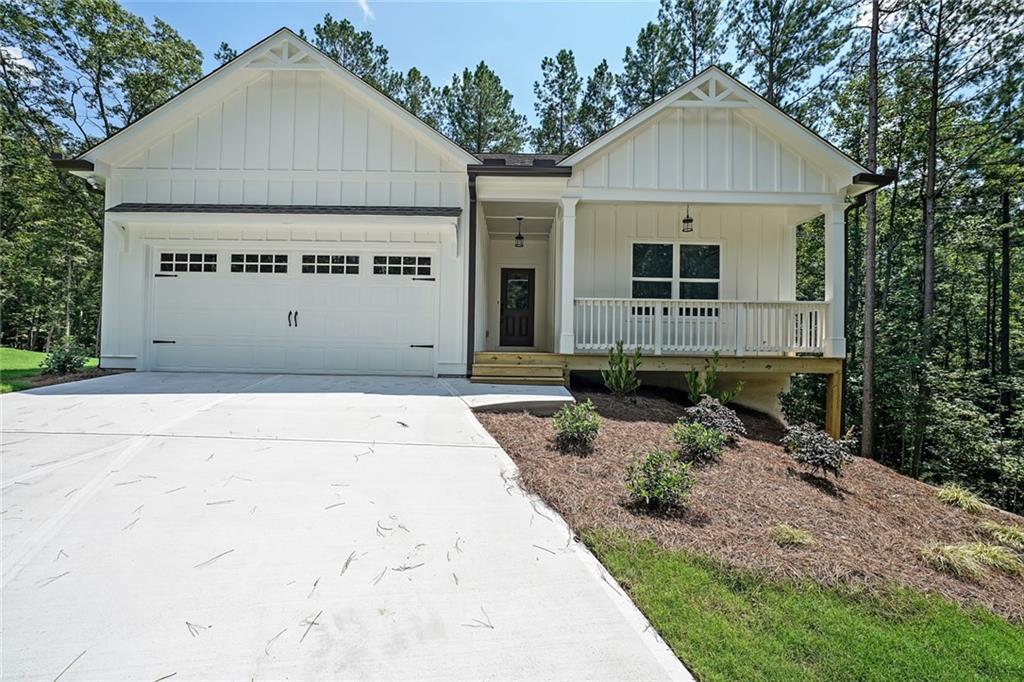 SO excited to announce NEW CONSTRUCTION by Rivermont Homes in the beautiful community, WEST WOODS! Fabulous location in Dahlonega just minutes from UNG campus offering Lumpkin county's finest schools and all the shopping close by in Dawsonville and the lovely downtown Dahlonega Square!!! The Oconee plan is a 3 bedroom 2 bath RANCH on a basement situated on .74 acres with a private wooded view. Entering this adorable home you have a spacious foyer leading to the living room which is open to a bright white kitchen featuring quartz countertops, large island, farmhouse sink and stainless steel appliances. A spacious master suite and the luxurious bath has a double vanity with quartz countertops, tile floor and large shower with bench. The 2 guest bedrooms offer ample space and closets with a shared hall bath. Home is READY NOW