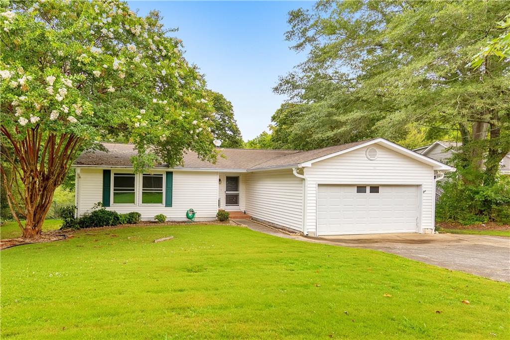 This is the one you’ve been waiting for! This charming 3 bed / 3 bath ranch home in the heart of East Cobb offers a brand new deck, newer carpet, and newer interior paint. The bright and airy kitchen flows seamlessly into the dining area, featuring an elegant pass-through window to the spacious living room with soaring ceilings, a wet bar closet, and a cozy stone fireplace. Unwind in the inviting sunroom that is perfect for morning coffee or reading a good book. This room could also be used as a third or fouth bedroom. Each bedroom enjoys its own private bath, while the primary suite boasts a large walk-in closet and an ensuite featuring dual vanities and a whirlpool tub. Step outside to a generous new deck overlooking the fenced backyard, and take advantage of the additional 3rd garage for extra storage space. Nestled in the sought-after Sprayberry High School district, with shopping and dining just minutes away!