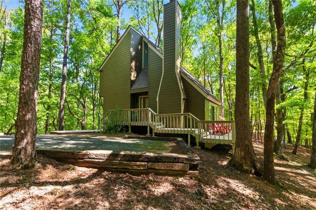 Tucked away on a peaceful cul-de-sac directly across from Indian Rocks Park, this chalet-style mountain cabin exudes warmth and charm. Step inside to soaring cathedral ceilings, wide plank pine floors, and a sunken living room with a cozy fireplace—the perfect gathering spot for family and friends. The open and inviting layout makes this home ideal for weekend getaways, a successful Airbnb, or your forever retreat in the mountains.
Thoughtful updates provide peace of mind, including a brand-new roof and septic service completed in July 2025. Outdoors, enjoy a partial gated wraparound deck that leads to a flat, private backyard—a rare find in the mountains and a wonderful space for little ones or pets to play. The level driveway with ample parking for 5+ vehicles adds to the ease and accessibility of this property.
Whether you’re seeking a quiet sanctuary, a family-friendly escape, or an investment opportunity, this charming chalet offers the best of mountain living in a truly special setting. Buyer to verify all information and dimensions deemed important.