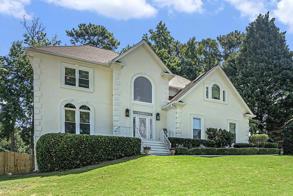 Traditional Charm in the Heart of the Sought-After Brookwood Community! Nestled in a well-established neighborhood with beautiful landscaping and the option to join the swim/tennis club and lake amenities, this spacious home offers an incredible lifestyle within the award-winning Brookwood School District. A Grand Two-Story Foyer welcomes you inside, setting the stage for the classic elegance found throughout. Hardwood Floors and Crown Molding adorn the main level, where a formal living room flows seamlessly into an adjacent formal dining room perfect for entertaining. The bright, white Kitchen features a large island with a breakfast bar, ample cabinet space, and a sun-filled breakfast nook overlooking the backyard. A light-filled Family Room with a cozy Brick Fireplace connects to a charming Sunroom with a wet bar, opening easily to the expansive Rear Deck. A convenient Half Bathroom completes the main level. Upstairs, the Primary Suite offers a true retreat with its own Fireplace, a spacious Walk-In Closet, and an Oversized Ensuite Bathroom featuring Dual Vanities, a Soaking Tub beneath skylights, and a separate shower. Three additional bedrooms share a generous Hall Bathroom, providing plenty of space for family or guests. The Finished Basement offers endless possibilities with a large Recreation Room, an additional Bedroom, and a Full Bathroom perfect for a media room, home gym, or in-law suite. Enjoy outdoor living on the Rear Deck overlooking a flat, fully fenced backyard ideal for play or gatherings. Located just minutes from shopping, dining, top hospitals, and with easy access to I-85 and Hwy 78, this home delivers both convenience and community charm. Optional swim/tennis and lake membership round out this exceptional opportunity in one of Gwinnett's most desirable neighborhoods!