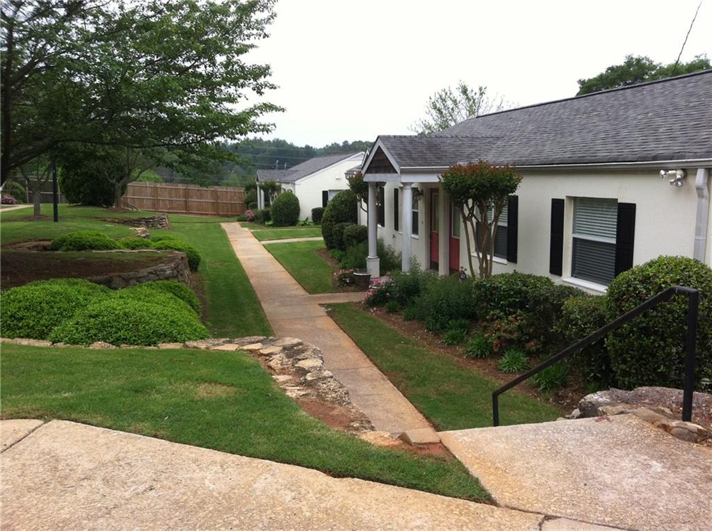 AMAZING KIRKWOOD LOCATION!!! This Duplex-Style Condo is a great home in a great location. Rent includes water, sewer, parking, garbage etc. Your only bill will be electricity. Located in a private gated community this home offers Intown living with a community pool, lovely open green spaces, and a fenced dog run. This adorable 2 bed 1 bath cottage has wood and lvp flooring, a vaulted ceiling, an open floor plan and eat-in counter in the kitchen which leads to the private back deck overlooking the tranquil pool. So, bring your BBQ and invite your friends and family. A terrific location close to Kirkwood Village, Little 5 Points, Caroline St. Shopping, and the Memorial Drive corridor's many restaurants and shops. A short drive to the Beltline's East and South side trails, and so much more. Includes one assigned parking space. Easy access to I-20 for commuting.