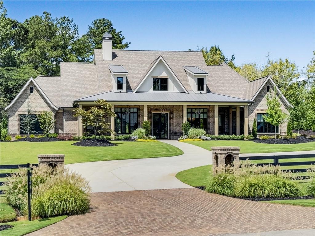 Welcome to your dream home! As you enter the driveway, you are greeted by two elegant columns adorned with beautiful gas lanterns, setting the tone for the charm and sophistication that awaits. Meticulously designed and built with the highest quality materials and cutting edge technology, this home is the epitome of modern luxury and durability. Every detail of this brand New Construction Home has been thoughtfully curated ensuring a unique and luxurious living experience. From the custom built details to the high end finishes. This Craftsman-style home offers luxury living in Alpharetta's sought-after Cherokee County. No detail has been overlooked! Boasting exquisite brick construction this home exudes elegance and charm. Nestled in Alpharetta, Georgia, this property offers the perfect blend of suburban tranquility and urban convenience. Enjoy easy access to top-rated schools (Avery, Creekland, Creekview and The Haven Academy), parks, shopping centers, and dining options. Experience culinary excellence with top-of-the-line appliances. Elevate your living space with locally crafted custom cabinets. Enjoy the timeless beauty and durability of stain in place hardwood flooring throughout the home. Our properties feature exquisite high performance concrete countertops with built-in sinks. Entertain in style with a fully equipped outdoor kitchen featuring Wolf and Sub Zero appliances. Relax in the shade of your 1000’ square foot covered patio, adorned with elegant herringbone solid brick detailing. Built in heaters on the patio will keep you cozy on those chilly nights. Prepare to be amazed by the meticulously designed master closet, perfect for that discerning client. Enjoy the luxury of heated Master Bathroom tile floors. From intricate trim work to designer fixtures, this home is filled with upscale details that set it apart from the rest. Prewired EV garage outlet. Control your HVAC, Lights, Surround Sound, and Lutron Window Shades effortlessly from your smartphone. Our roofing materials are made with F Wave premium synthetic roof shingles and offer a lifetime warranty. They are made to with withstand 130 mph winds, Class 4 Hail, and Class A fire protection. Our Casement windows are backed with a 10 year warranty (20 year glass warranty). With too many upgrades to mention, this home offers luxury living at its finest. In addition to the main living and bonus square footage, this home includes an additional 2411 square feet (front and rear porch plus garage) for a total of 6434 square feet (under roof and all other areas). Showings scheduled upon receipt of Proof of Funds (POF) or PreQual Letter. Listing agent will be present for all showings to provide intricate details of this exquisite property. This subdivision will have a total of 7 New Homes and is a Preplanned Community. Individual Lots are not for sale. Backyard is approved for an inground pool. Schedule your showing today and ask me about our creative financing options!