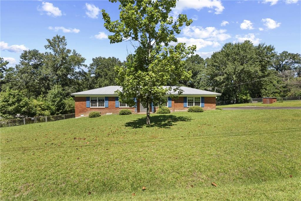 What a find! Sitting just over half an acre, But even better is the space of the all brick house, with 3,340 sq feet! The roof is approximately five years old. A brand new Septic Tank was installed in 2022.