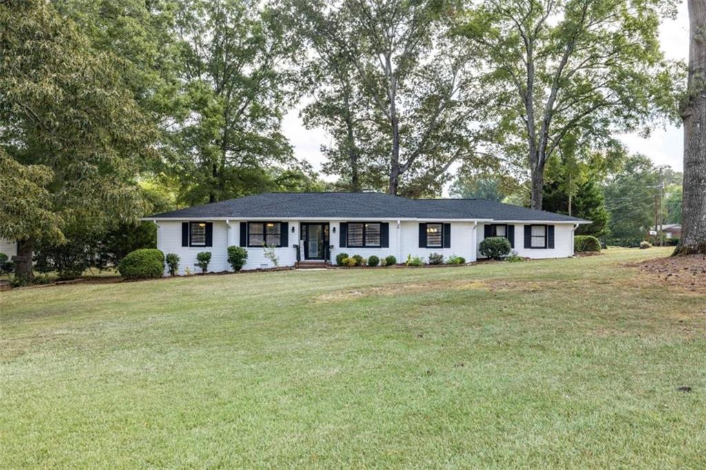 Completely remodeled brick ranch just steps from Cherokee Golf Course! This 3-bedroom, 2-bathroom home is move-in ready with all new paint, flooring, light fixtures, plumbing fixtures, doors, tankless hot water heater, and brand-new roof. The updated kitchen features granite countertops, stainless-steel appliances, and lots of cabinet space. The oversized primary suite features a large walk-in closet and a luxury tile bathroom with a 6-foot double shower, frameless glass shower door, double vanity and gold accents. The home also offers a convenient 2-car attached garage with utility room perfect for storage or a workshop. Outside, enjoy fresh landscaping, a level open yard, and an outbuilding for extra space.