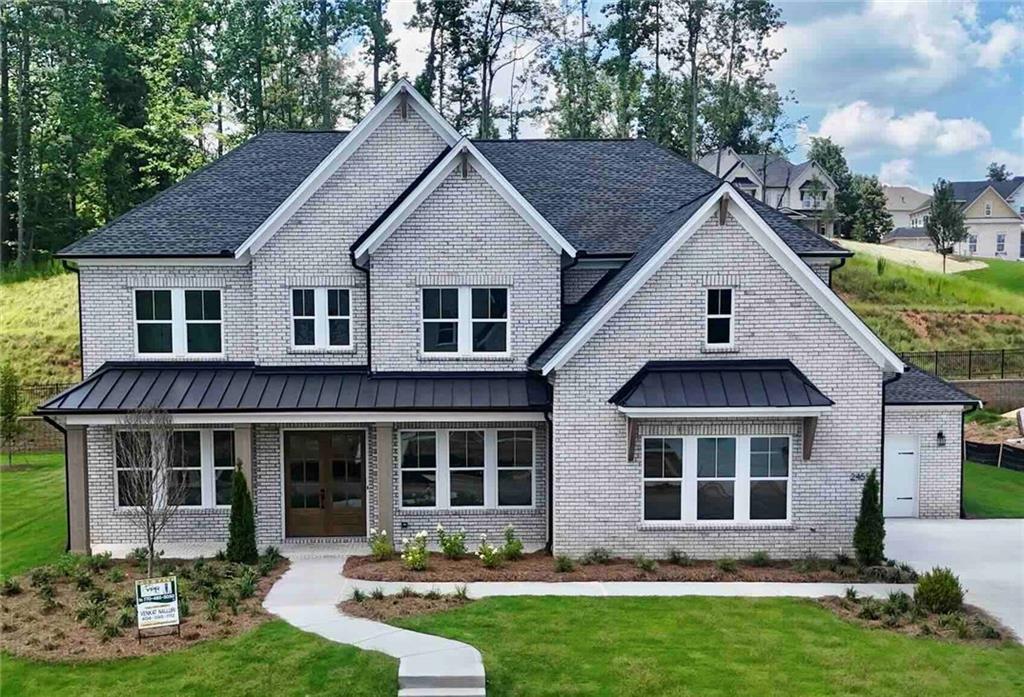 This beautifully crafted northeast-facing luxury home features 5 bedrooms, 5.5 bathrooms, and the sought-after Payton floor plan, offering approximately 4086 square feet of elegant, well-designed living space. Move-in ready and set on a premium lot in the prestigious CrossCreek community by Toll Brothers, the property includes a rare oversized private backyard—ideal for entertaining or relaxing in privacy.
A striking double-door entry leads into a light-filled, contemporary interior highlighted by upscale finishes throughout. The main level boasts wide-plank Mariner Oak engineered hardwood flooring, while the upper level is finished with plush Taverne Creek carpeting. The open layout is anchored by a dramatic fireplace with polished tile surround and soaring ceilings that enhance the sense of space and light.
The heart of the home is the gourmet kitchen, complete with a large quartz island, full-height cabinetry with glass uppers and accent lighting, a full quartz backsplash, and built-in KitchenAid stainless steel appliances. Each bathroom offers spa-like touches with quartz countertops and frameless matte black glass showers.
A flexible Multigen Suite on the main floor—perfect as a private guest space, theater room, or home office—adds versatility to the layout. The home also features a 10-foot drop zone with built-in storage, matte black hardware, designer gold light fixtures, and a sleek contemporary trim package.
Additional highlights include a side-entry three-car garage with a carriage bay, ample parking and storage, and a full irrigation system for easy outdoor maintenance.
Conveniently located just minutes from GA 400, The Collection, Halcyon, Avalon, and Fowler Park, this exceptional home delivers luxurious living and everyday convenience in one of the area’s most desirable communities.