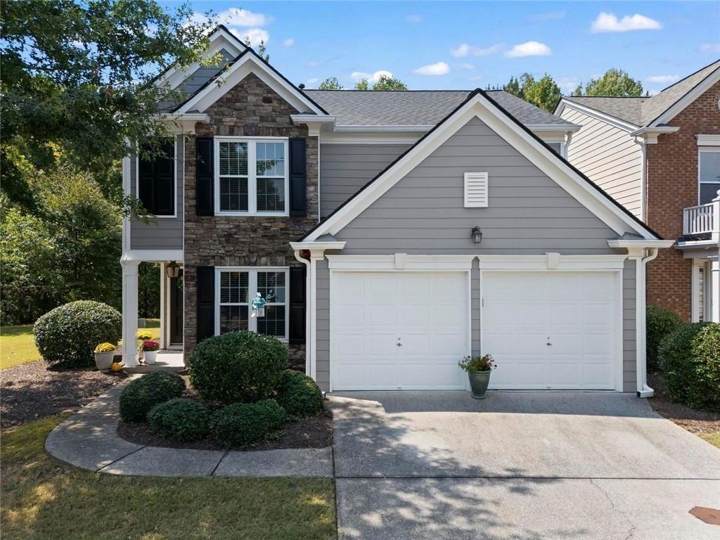 Beautiful home in the popular neighborhood, The Woodlands. Easily accessible to both downtown Woodstock and downtown Roswell, The Woodlands provides fabulous and fun amenities, including pools, tennis courts, clubhouse, volleyball, basketball, and a large playground. Main pool has a fun waterslide! The home has been lovingly and extensively updated. Kitchen has beautiful granite counters with a subway tile backsplash. Stainless appliances include a gas range. Recent updates to the primary bath include granite counters, new sinks, lovely tile, new plumbing fixtures. The home provides an open flow with hardwood floors throughout and includes a main floor office. The garage has a newly finished epoxy floor. A large patio overlooks a level grassy backyard. Each unit is attached at a storage area in the back, creating a single- unit-look though attached at that one area. The home has a newer roof, windows, sliding glass doors, pantry doors, and additional lighting. This home is sunny and inviting!