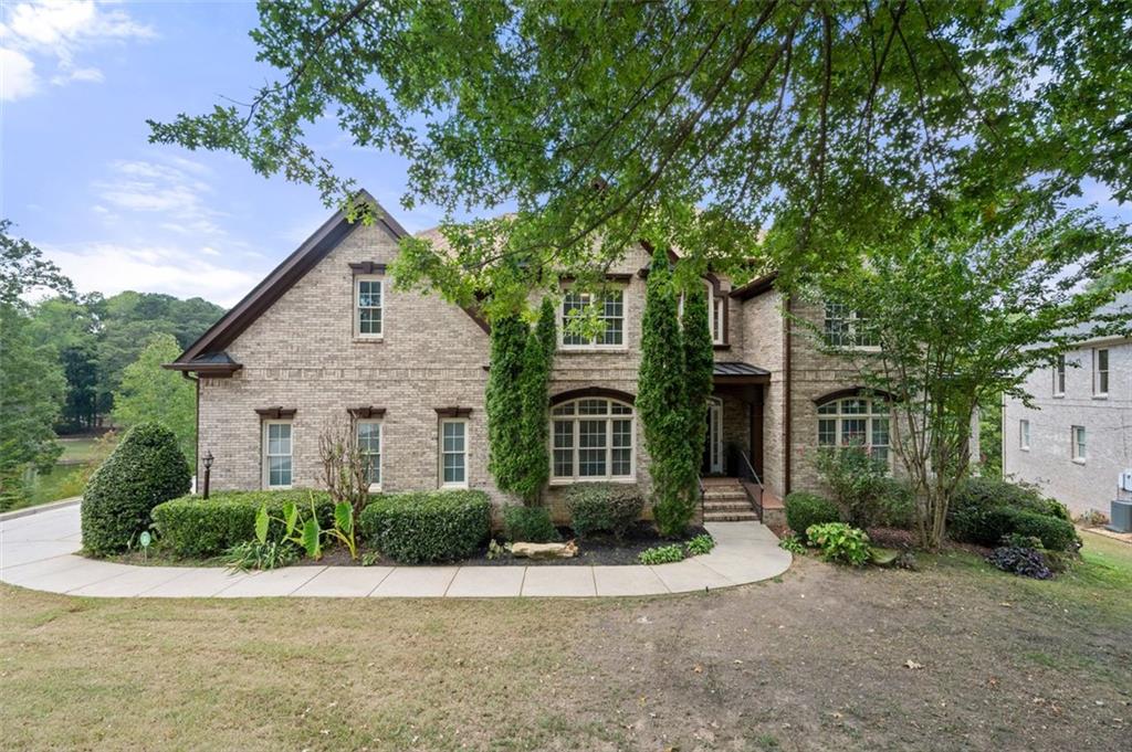 Back On Market, At No Fault to the Sellers. Introducing an exquisite 4,452 square foot lakefront property with 5 bedrooms, 6 bathrooms, situated on a cul-de-sac. Nestled in a sought-after neighborhood with a community pool and tennis courts, this remarkable custom built home exceeds expectations. The grand foyer welcomes you with a formal dining room and a flex room that could be used as an office or sitting room. The first level also features a fireside living room with tons of natural light, and a connection to the brand new custom built deck and side covered porch, allowing for cozy gatherings and indoor-outdoor living. Adjacent to the living room, discover the beautifully equipped kitchen, a chef's delight, boasting a gas cooktop, tiled backsplash, quartz countertops, and stainless steel appliances. This gourmet kitchen also boasts double convection ovens, perfect for the home chef who loves to entertain. The kitchen is complemented by custom cabinetry that not only enhances its aesthetic appeal but also provides ample storage for all your kitchen essentials. A well-appointed and stylish half bath completes the first level. The upper level features a luxurious owner's suite with tray ceilings, separate his/hers vanities in the ensuite bathroom, large walk-in closet, oversized shower, and whirlpool tub. With a dual fireplace in your Owner's suite and bathroom, you’ll enjoy a seamless blend of comfort and sophistication. Three additional bedrooms and two additional bathrooms complete this level. The basement features a bedroom, full bathroom, powder room, gym, open concept flex space, and bar. Step into your personal entertainment oasis with this stunning full bar, designed to elevate your hosting experience. Featuring elegant cabinetry, the bar is fully stocked with ample space and equipped with sleek granite countertops that offers plenty of room for serving drinks, as well as a dedicated sink for easy cleanup. Excellent location -- this lakefront property is conveniently located near Camp Creek Marketplace, Princeton Lakes Shopping Center, Downtown Atlanta, Hartsfield-Jackson Atlanta Airport, Shopping, Restaurants and the major interstate I-285. Welcome home!