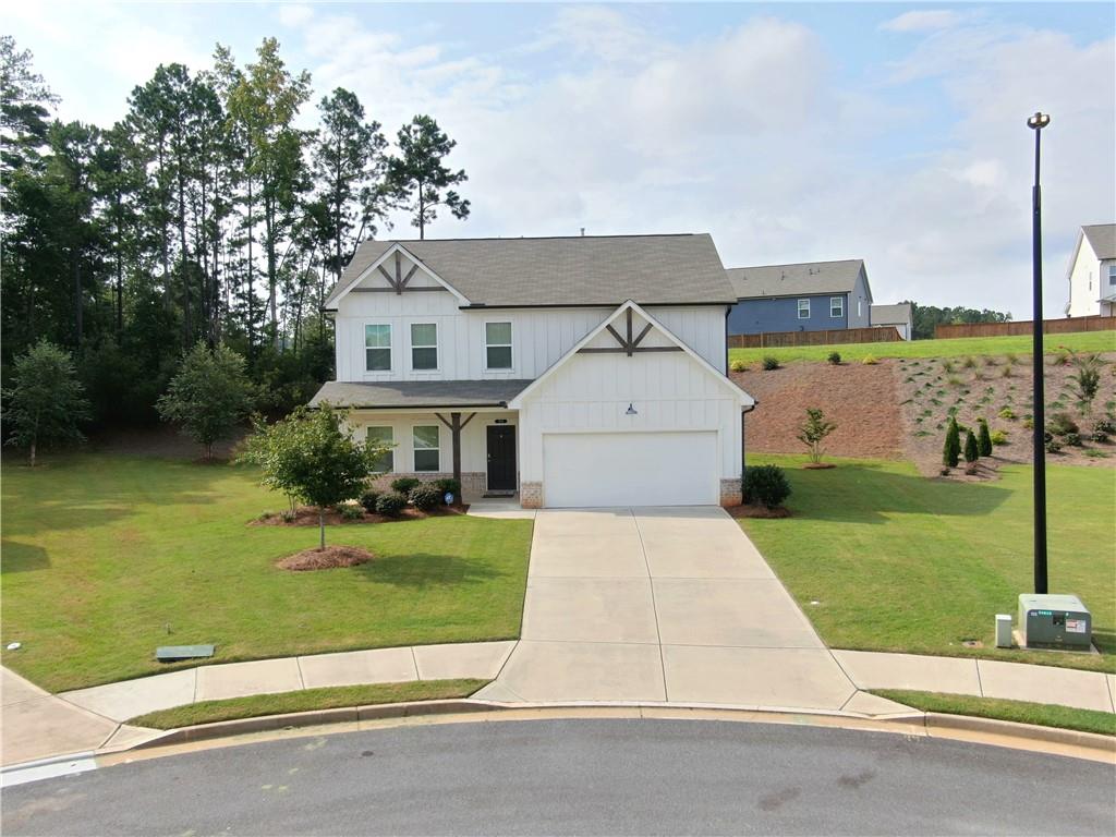 Welcome Home to Acworth! This beautiful 4-bedroom, 2.5-bath residence blends modern comfort with timeless style, offering the perfect retreat for families who love both entertaining and quiet evenings at home. Step inside to discover a bright and open floor plan. The spacious living room with a cozy fireplace sets the tone for gatherings, while the large windows flood the space with natural light. The modern chef's kitchen is a showstopper complete with stainless steel appliances, a central island, custom backsplash, and plenty of storage. Enjoy casual meals at the island or host dinner parties in the elegant dining room with stylish lighting. Upstairs, the primary suite is a true retreat with space for a sitting area, a spa-inspired bathroom with dual vanities, soaking tub, and walk-in shower. Three additional bedrooms provide flexibility for family, guests, or even a dedicated home office. The loft area upstairs offers a cozy second living space perfect for movie nights, a playroom, or a quiet reading nook. Step outside and enjoy a generous backyard and lush landscaping, offering plenty of room for kids, pets, or weekend barbecues. The covered front porch and curb appeal make this home truly stand out in the neighborhood. Located in the heart of Acworth, GA, you'll be just minutes from excellent schools, shopping, Lake Allatoona, and I-75 for an easy commute.