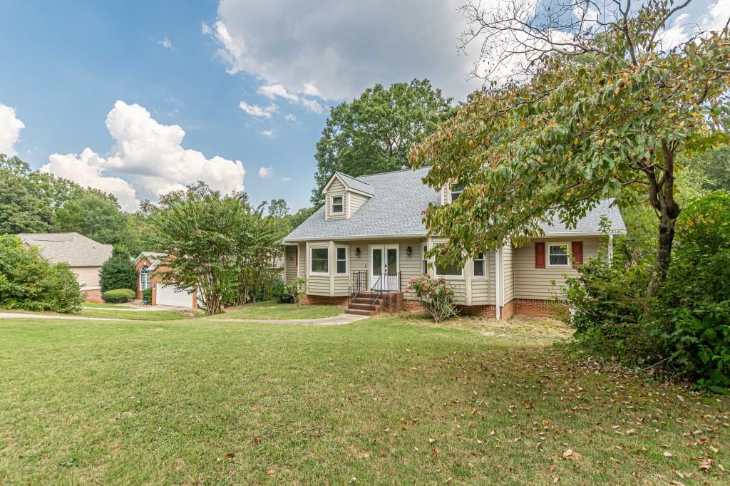Well-Built & Updated Home in Established Neighborhood - No HOA! Beautifully maintained 4BR/3BA home on a wooded lot with creek. Spacious layout features a welcoming foyer, formal dining & living rooms, and an updated kitchen (2023) with gorgeous cabinetry, modern flooring, breakfast bar, and sunny breakfast room. All appliances stay -- including washer & dryer! The great room offers a cozy brick fireplace and opens to a large back deck with tranquil views. Owner's suite on main with dual vanities in ensuite bath. Upstairs includes two oversized bedrooms with Jack & Jill bath. Finished terrace level with additional bedroom, full bath, and bonus room -- ideal for office, rec room, or guest space. Recent updates: New siding, new roof (2024), new windows, leaf filter gutter system, whole-house generator. Exterior: Low-maintenance -- no painting needed! Move-in ready in a quiet, established community -- no HOA fees!