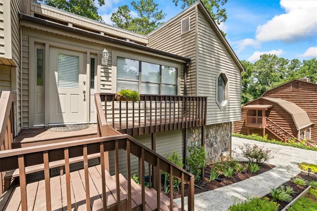 Discover your dream home in this stunning contemporary split-level property, perfectly situated in east cobb. With its top-rated schools and easy access to I-75, this home offers the ultimate lifestyle. As you approach, you'll be struck by the picturesque rose bushes and expansive front yard, perfect for outdoor relaxation. Inside, the soaring cathedral ceiling family room features a beautiful stone front fireplace, bathing the space in warmth and natural light. The sleek, remodeled kitchen boasts European-style cabinets and stainless steel appliances, flowing seamlessly into the perfectly sized dining room. Upstairs, the expansive master bedroom and two additional bedrooms await, along with fully renovated master and guest bathrooms. The lower level offers endless possibilities, with a generous room perfect for a game room, a fourth bedroom with a full bathroom, and a convenient laundry room. Outside, three expansive decks and a greenhouse beckon you to explore your creativity. All new windows, fresh interior paint , New garage doors, New AC unit, All exterior pressure washed. all within walking distance to shops, Sprayberry Walk, and restaurants.