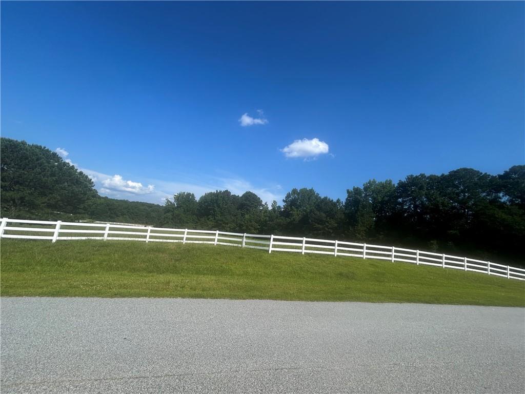 Bring your boots and your blueprints! This gorgeous 4.59-acre corner lot in the established Longview Landing subdivision offers the rare combination of peaceful country living and upscale neighborhood charm. Bordered by a classic white rail fence and framed with lush greenery, this cleared and level parcel is primed for your dream home, barn, or both. It's one of the few remaining large lots available in the subdivision and is ideal for a custom-built home, a small farmette, or anyone simply wanting more space to spread out. Located approximately 40 minutes from downtown Atlanta, the property feels a world away from the hustle and noise of the city. The area is equestrian-friendly featuring a horse trail around the entire neighborhood, and just minutes from the Georgia International Horse Park, with nearby access to grocery stores, dining, and shopping in both Covington and Oxford. The white vinyl fence adds a polished curb appeal while clearly defining the property boundaries. The lot's prime corner location offers flexibility in designing your driveway and home layout, and the paved road frontage with utilities already available makes the building process even easier. Ask how you can receive up to $500 credit by using one of our preferred lenders. Exclusions may apply.
