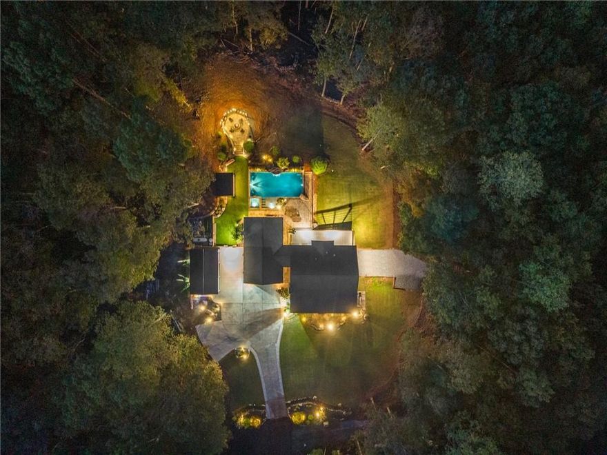 Welcome to your private five-acre sanctuary in the heart of Dawsonville. This custom-built home offers the perfect blend of luxury, comfort, and tranquility, designed for both everyday living and unforgettable entertaining. From the moment you arrive, you’ll be surrounded by beautifully landscaped grounds and the peaceful privacy of North Georgia living.

Step inside to discover a thoughtfully designed floor plan featuring four spacious bedrooms and three full bathrooms. The inviting living and dining spaces provide the perfect balance between open-concept flow and defined areas for entertaining or quiet moments. The fully finished basement offers flexible living options with space ideal for a media room, guest suite, or home gym. Built in 2002 and meticulously maintained, the home features stylish upgrades throughout, offering both elegance and warmth in every detail.

The backyard transforms this property into a true resort-style retreat. Enjoy a custom gunite pool with a hot tub spa, an outdoor kitchen and dining area, a cozy fire pit, and a stunning outdoor fireplace perfect for cool evenings. A private music stage adds a one-of-a-kind feature—ideal for events, performances, or simply enjoying live music under the stars.

 A Home That Grows With You
This property combines privacy, elegance, and lifestyle — with the flexibility to make it truly your own. Whether you keep the charming traditional layout or open it up for a modern flow, 255 Reece Rd offers endless possibilities to fit your dreams.

Located just minutes from Amicalola Falls State Park, Iron Mountain Park, and Atlanta Motorsports Park, this home provides the perfect balance of serenity and convenience. Whether you’re seeking a private getaway, a home built for entertaining, or a lifestyle property surrounded by nature, 255 Reece Rd offers it all.

Your dream home awaits — where every day feels like a getaway.