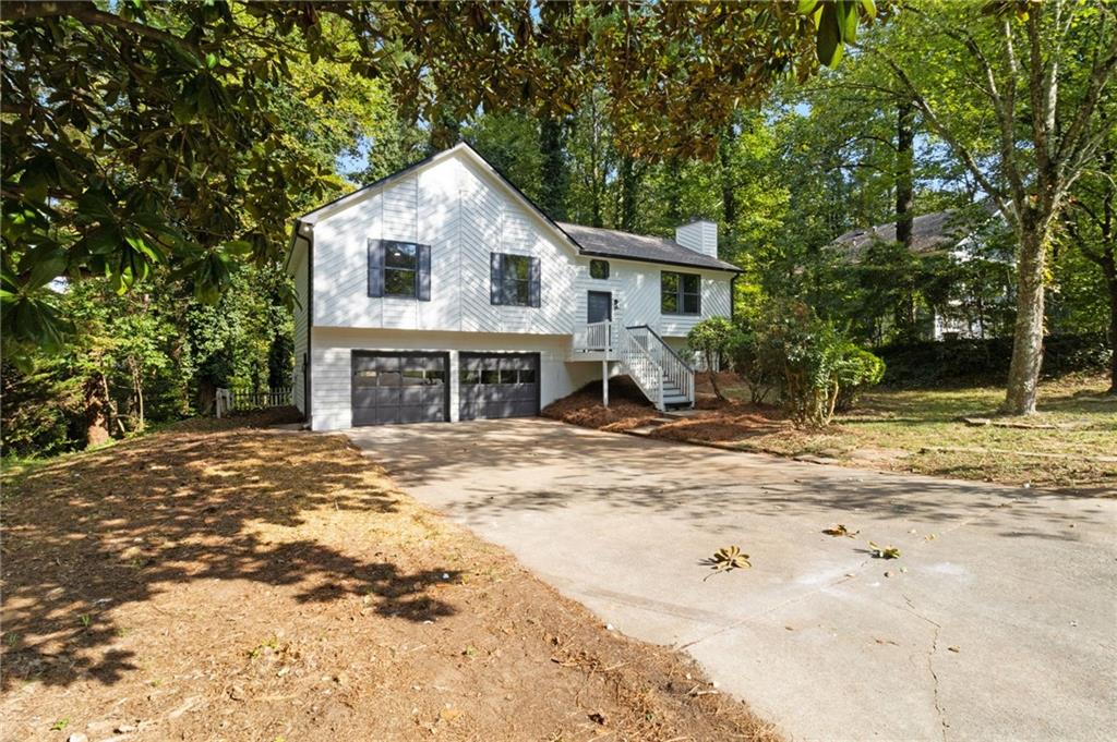 Stunningly renovated 4 bed/3 bath home with two Master Bedrooms/In-Law suite in the basement featuring brand new Luxury Vinyl Plank flooring, brand new 30-yr Architectural Roof, new interior and exterior paint, new lighting and plumbing fixtures everywhere, new granite countertops in kitchen and bathrooms, and new stainless-steel appliances. Home offers beautiful curb appeal with a 2-car garage. Enter into the large open floorplan living room offering large windows to allow in lots of natural lighting, fireplace, and views to the kitchen. Kitchen offers new granite, new cabinets, plenty of cabinets and countertops space, huge island with overhang perfect for barstools, stainless steel appliances, and large eat-in dining area. Main level Master bedroom offers an En-suite with walk in shower, new granite, and low flow toilet. Two good sized secondary bedrooms and secondary bathroom upstairs with tub/shower combo, low flow toilet, and new granite. The basement offers a large second Master bedroom/In-Law suite and En-suite with double vanity, low flow toilet, and walk in shower. Out back the deck and patio overlook the fenced in backyard.