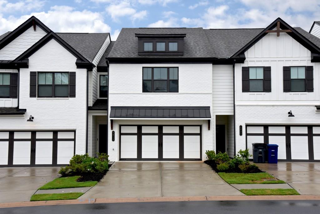 Welcome to Cypress Park! This stunning 2022-built modern townhome offers the perfect blend of style, space, and convenience ideally located near I-985 and just minutes from top-rated schools, shopping, dining, and more. Featuring 3 spacious bedrooms and 2.5 baths, this home is designed for comfort and functionality. The open-concept main level boasts beautiful hardwood flooring, a sleek electric fireplace with custom mantle, and a chef-inspired kitchen complete with granite countertops, stainless steel appliances, a large island with pendant lighting, and ample cabinet space. Upstairs, you'll find a generous primary suite with a tray ceiling, oversized walk-in shower, dual vanities, and a large walk-in closet. The two secondary bedrooms share a bright and stylish full bathroom and offer deep closets for extra storage. The laundry room, conveniently located on the same level as all bedrooms, includes a nearly new GE washer and dryer. Enjoy a 2-car garage, private back patio, and low-maintenance living in this beautifully maintained community.