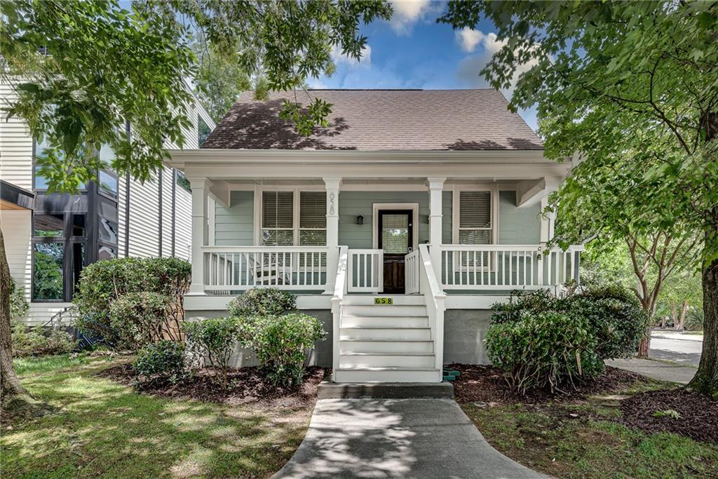 This corner-lot gem sits right where Old Fourth Ward meets Inman Park—less than a tenth of a mile from the Eastside Beltline Trail and Krog Street Market. Relax on your rocking chair front porch, just steps away from Atlanta's best dining with a rare 94 walk score. Two primary suites (one on each level) plus a third bedroom offer maximum flexibility, with the main-level suite featuring a private balcony, walk-in closet, and full ensuite, while the oversized upstairs primary boasts double vanities, separate shower, and soaking tub. Gorgeous site-finished hardwood floors flow through both levels of this move-in ready home with fresh paint inside and out, open-concept living with vaulted ceilings, cozy fireplace, and abundant natural light. The low-maintenance fenced yard handles kids and dogs without the upkeep headaches, plus you get a Trex deck, classic rocking chair front porch, and off-street parking for two cars—a huge win in this walkable neighborhood with sidewalks, bike lanes, and quick transit access. This is urban density done right: your own space with a yard and parking, but connected to everything that matters in Atlanta.