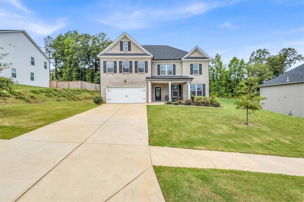 Welcome to The Sinclair Plan in Monet Gardens! This brand new home features 5 spacious bedrooms and 4 full baths in a quiet community of just 18 homes. Enjoy easy access to I-20 along with nearby shopping, dining, and everyday conveniences. The open kitchen includes stainless steel appliances, a large island, and a generous walk-in pantry. A guest bedroom and full bath on the main level make this home ideal for multi-generational living or visitors. Upstairs offers a versatile loft space perfect for a second living area, home office, or playroom. The oversized owner’s suite features dual vanities, a large walk-in closet, garden tub, and separate shower. Thoughtfully designed with modern comfort and function in mind — this home has everything you need.
