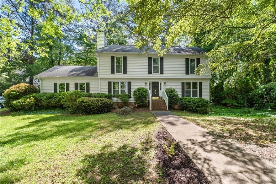 Truly move-in ready and fully updated 3-story home located in one of Atlanta’s top rated school districts! This spacious 5BR/3.5BA home offers a fully remodeled daylight basement with new flooring, updated full bath, and private exterior entry—ideal for a guest suite or potential for rental income. New under-decking with advanced lighting expands your outdoor living space. Home features all-new windows, upstairs HVAC, hot water heater, oven, microwave, and newer garage doors. Kitchen, all bathrooms, and basement have been completely remodeled. New hardwood staircase and wood floors throughout. Oversized owner’s suite includes private deck. Enjoy peaceful mornings or relaxing evenings on the two-level deck in this private, wooded setting. Side yard extends to the right and has room for a pool—several homes in the community have done so. Interior freshly painted in 2024; exterior painted in 2023. Located in a quiet, established neighborhood just minutes from the Braves Stadium, The Battery, top dining, shopping, and major highways. 12-month home warranty included.  All major systems and finishes updated within the last 1–3 years. A rare private retreat with unbeatable location and top-rated schools—this one is a must-see!