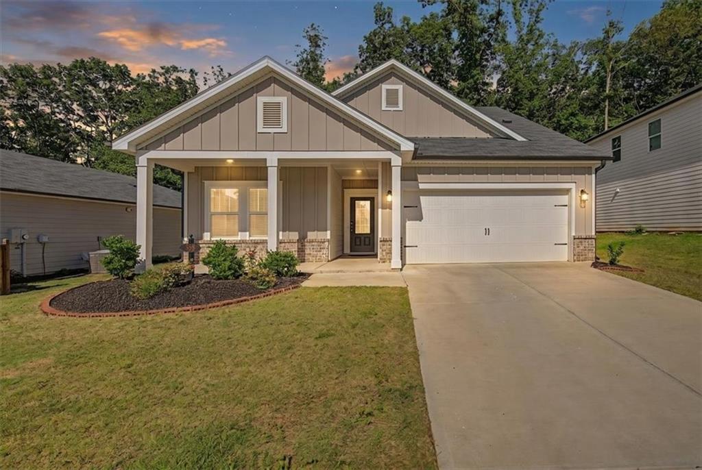 Contemporary facade with board and batten siding, stone accents, and a covered porch