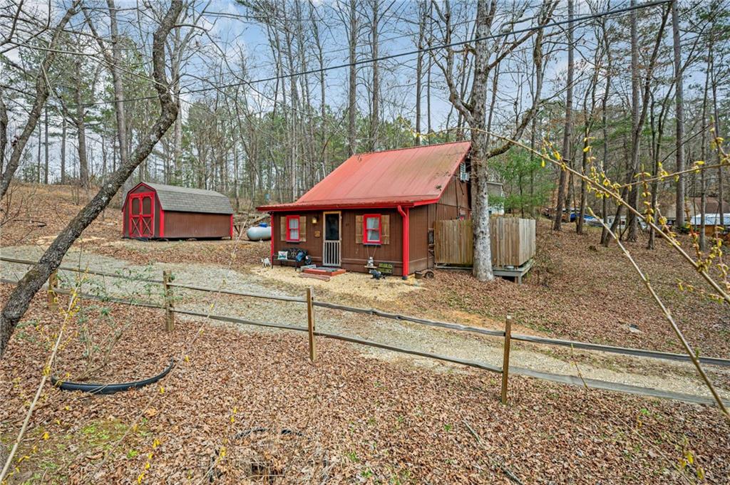 YOUR OWN GINGERBREAD HOUSE! This super cute 2 bed, 1 bath cottage is the perfect place for full-time living, weekend retreat, or short and long-term rentals. Home features vaulted ceilings, hardwood floors, country kitchen, outdoor patio with grill and hot tub, and a generously oversized lot of just under an acre. Home is being sold fully furnished. This gem is a must see!! Don't let this one get away!
