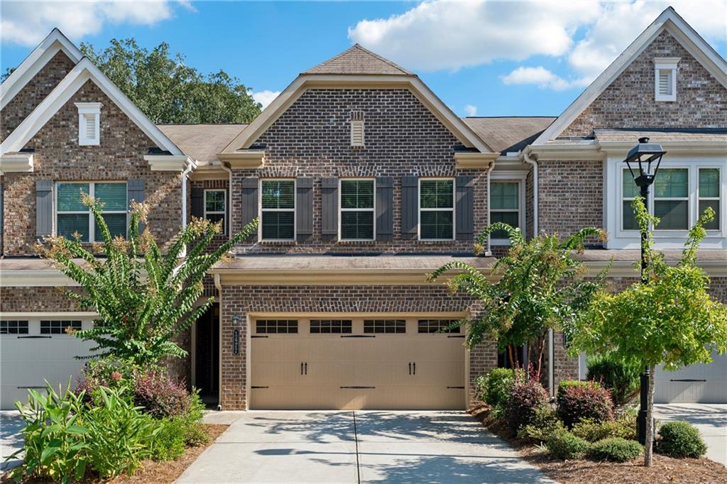 Welcome to 1477 Lanier Vista Drive! This beautifully maintained 3-bedroom, 2.5-bathroom townhome is located in the highly sought-after gated community of Lanier Park in Sugar Hill. Featuring an open-concept floor plan, the main level offers a warm fireside living room that flows into the dining area and a well-appointed kitchen with stained wood cabinetry, granite countertops, and a spacious walk-in pantry. Upstairs showcases hardwood flooring throughout, a large primary suite with a soaking tub, separate shower, and dual vanities, plus two additional bedrooms and a convenient upstairs laundry. Enjoy outdoor living with a private patio and newly fenced backyard, perfect for pets or entertaining. Additional highlights include a 2-car garage, abundant natural light, and access to a community pool and secure gated entry. Located minutes from shopping, dining, and top-rated schools, this townhome offers comfort, style, and convenience in one of Sugar Hill’s most desirable communities.