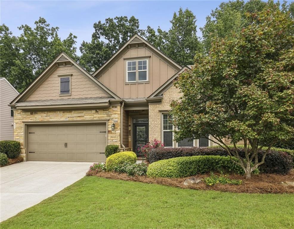 Master-on-Main. $77K in upgrades and renovations. Lawn maintenance included in HOA. Motivated Seller; will contribute up to $10,000 toward Buyer's Closing Costs with full-price Offer. Meticulously maintained Craftsman Ranch. This move-in-ready home on a cul-de-sac in the sought-after Kingswood Community of South Forsyth. From the moment you arrive, you’ll notice the meticulous attention to detail—and the stunning walk-out backyard will leave you speechless. Fully fenced for privacy and framed by acres of serene woods, this outdoor oasis features professional landscaping, a spacious patio, and a 14-foot remote-controlled SunSetter awning with integrated LED lighting. An adjacent covered lanai—already wired and ready for a big-screen TV—makes it perfect for fall football, while the stone firepit keeps the good times going on chilly nights. Inside, the two-story Great Room welcomes you with a striking wood-and-iron staircase leading to an oversized loft, full bedroom, and bathroom—ideal for guests, family, or a home office. Much of the first level has brand-new LVP flooring, and the Great Room is pre-framed for a fireplace so you can personalize it to your style. A coffered-ceiling Dining Room seats up to 12, while the open-concept Kitchen shines with granite countertops, a center island, updated stainless steel appliances (gas range, refrigerator, microwave, and dishwasher), full-size pantry, and a stylish tile backsplash. The Master-on-Main overlooks the wooded backyard, creating a tranquil retreat with a spa-style bath featuring dual sinks, a soaking tub, separate shower, private water closet, and a custom walk-in closet for two. Owners installed a state-of-the-art water filtration and water softening system raising the spa-style to a new level. Two additional bedrooms share a full bath with separate vanities, and guests will appreciate a completely separate powder room. A formal foyer, full-size laundry room, and two-car garage complete the main level. Kingswood is a vibrant, active HOA community offering a clubhouse, pool, tennis/pickleball courts, and year-round social events. All of this is just minutes from GA-400, The Collection at Forsyth, Northside Forsyth Hospital, Cumming City Center, Big Creek Greenway and the highly anticipated new Whole Foods Market.