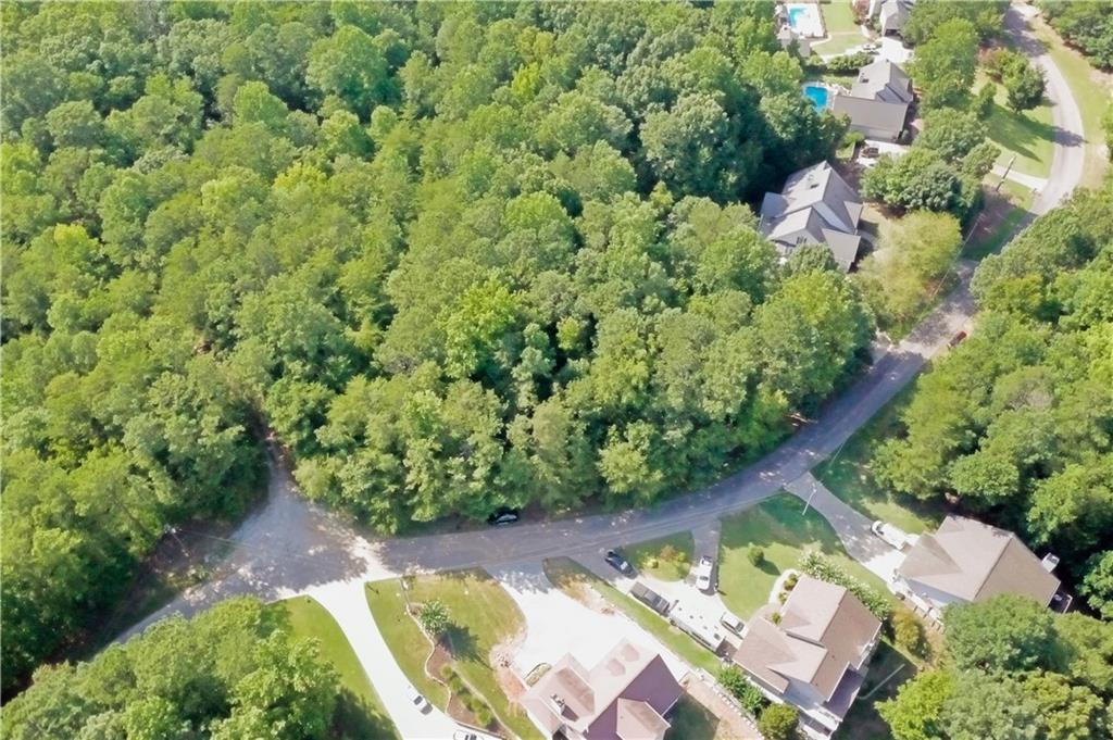 Exceptional 0.768-Acre Homesite Near Lake Lanier – Build Your Dream Estate
Discover a rare opportunity to own a private and beautifully wooded 0.768-acre lot nestled in a quiet, established area near Lake Lanier. Located on the desirable Goddards Ford Rd, Lot #61 offers a gentle slope ideal for a basement home and boasts mature hardwoods, creating a tranquil, natural setting for your future custom residence. This homesite is part of a lightly restricted neighborhood with no HOA, giving you the freedom to bring your own builder and vision to life. Soil test, survey, and an expired, but previously approved—construction permit are available. Conveniently located minutes from boat ramps, parks, shopping, and dining, with easy access to downtown Gainesville and major highways. No lake frontage or dock slip—just peaceful living in a sought-after location. Don’t miss this opportunity to create a truly personal retreat.