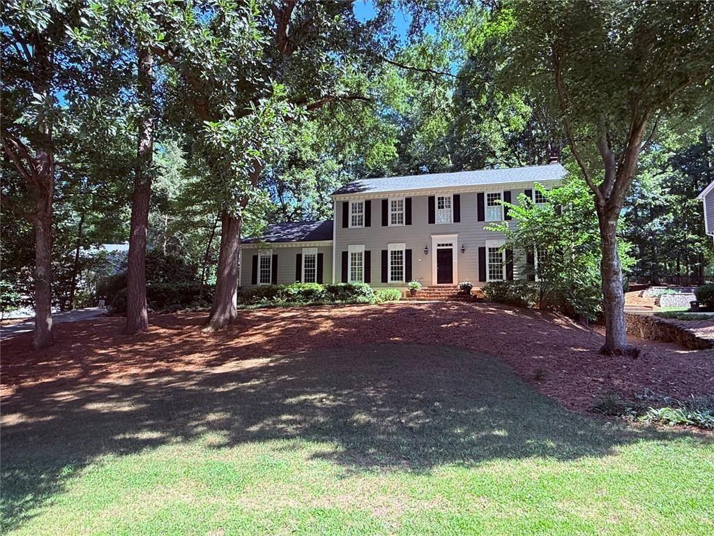 Welcome to 1160 Old Woodbine Rd, a beautiful two-story traditional colonial style home located in the sought-after neighborhood of Derby Hills. Fabulous curb appeal and priced below market. This light-filled home features a welcoming entry foyer and hardwood floors heavy moldings and wainscotting throughout the main level. The open kitchen features a coffered ceiling, granite counters, an island, and ample cabinet space. It includes a keeping room with views of the backyard and a new deck. The main level also includes a formal living room, a den with built-in shelving and a wood-burning masonry fireplace (recently rebuilt firebox), a separate dining room that seats 12+ for special occasions, and an elegant powder room. Completing the main level is a separate laundry room and a large side-entry two-car garage.
Upstairs, you'll find a new hardwood landing, beautiful crown moldings and a large master suite with custom closet systems and a renovated master bath featuring double vanities and marble counters. There are three other generously sized secondary bedrooms and a full bath with granite counters, terrazzo tile, and an oversized jacuzzi. New carpet is installed throughout the upstairs.
The fully finished terrace level, with both exterior and interior entry, boasts a full bath, a large bonus area with built-in shelving, a new ceiling, a pool table, masonry fireplace with gas logs and ample storage. Additionally, there is a surround sound system.
The sweeping front yard offers lovely curb appeal, and the professionally landscaped grounds include a lovely backyard with a brand-new deck. The home has a new roof, and many of the systems have been recently replaced or updated. Conveniently located near top schools, parks, shopping, dining, and major hospitals (Pill Hill), with easy access to GA-400 and I-285, this home is must-see.