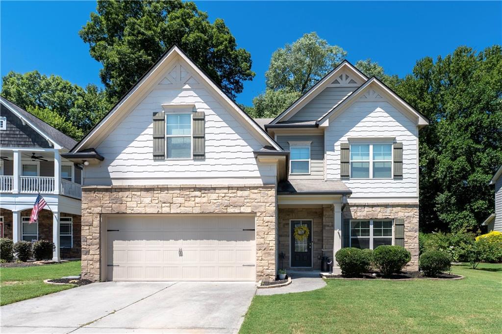 The sellers are highly motivated, and this home is priced to sell—an incredible opportunity to live in one of Braselton’s most sought-after communities. Life feels a little sweeter in Riverstone Park, and this 4BD/3BA Craftsman sits right in the heart of it all. Just a golf cart ride away from playgrounds, pickleball matches, pool days, and neighborhood events where everyone knows your name, this is a home made for connection and comfort.
Step inside to an inviting layout with a full bedroom and bathroom on the main floor—perfect for guests or a private home office. The kitchen, with its oversized island, sets the stage for everyday meals and weekend gatherings. The living room fireplace adds cozy charm, while the dining room’s wainscoting brings timeless character. Upstairs, you’ll find a spacious primary suite for unwinding, a shared Jack-and-Jill bath between two bedrooms, and a versatile loft space for movie nights or homework hangouts.
End the day outdoors under the covered patio, fireplace crackling, favorite show on the mounted TV, and neighbors waving as they drive by in their golf carts. This home offers comfort, community, and convenience all in one perfect package—don’t miss your chance to make it yours before it’s gone.