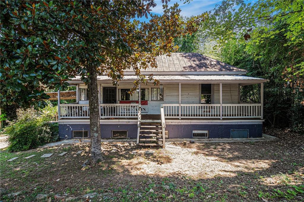 Check out this adorable home in a great location in Athens. The home has a metal roof and massive front porch and full basement which is finished. Spacious kitchen upstairs and a small full kitchen in the basement. Basement has 2 bedrooms and a full kitchen as well as a large living area. There is storage and a laundry room. Upstairs has hardwood floors, a large living room and tons of natural light. Two full bathrooms and extra room which would be great for an office or media room is in the back of the home. Great features of the home are plenty of parking in the back of the home as well as a carport. A short drive from the college and downtown. A couple of blocks from Dudley Park and a quick drive to Olympic drive exit. Home has been used as a rental and could easily be a residential home again.