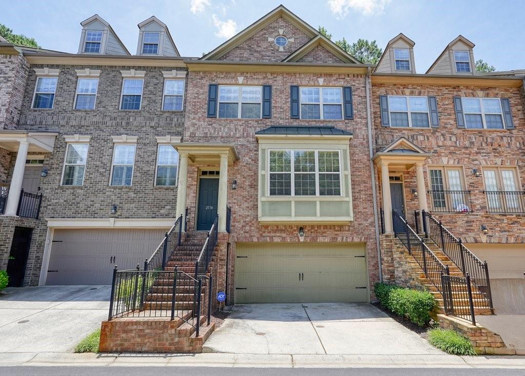 Location, location, location! Discover the perfect blend of comfort and convenience in this 3-level townhome nestled within a coveted gated community. Enjoy a spacious layout featuring 4 bedrooms and 3 full bathrooms, plus a convenient half bath on the main living level. The top floor boasts a luxurious primary suite, along with two additional bedrooms and a full bathroom, as well as convenient laundry on the same floor. On the main living level, you'll find an the eat-in kitchen with build in desk, space for an additional dining area, and a stunning fireplace in the large living room. The lower level offers a bedroom and full bathroom, perfect for a home office, guest suite, or recreation room. This lovely home is conveniently located near I-75, providing effortless commutes and easy access to the surrounding areas. Explore nearby parks such as Sewell Mill Park and Terrell Mill Park, which offer hiking trails, sports fields, and playgrounds. Battery/Truist Park just 15 minutes away. With close proximity to a variety of shops and restaurants. Great schools in the area!
