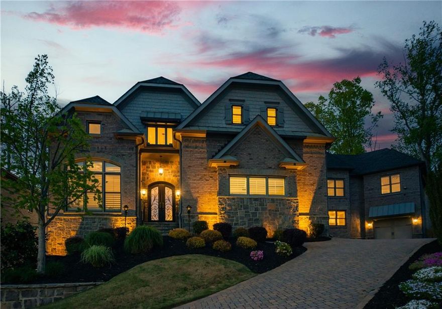 Nestled at the end of a serene cul-de-sac in the prime East Cobb area, and highly sought after Walton High School district, this exceptional property offers the rare opportunity of two homes in one.  A harmonious blend of luxury, privacy, and convenience awaits in this beautifully designed estate, lavishly appointed with high-end features and amenities.  This magnificent residence is four sided brick w/stone accents and a private backyard.  The main house boasts five bedrooms with en-suite bathrooms and one powder room including a spacious bedroom on the main floor for those looking for a step-less solution. Enjoy gatherings in the open great/family room with soaring 12-foot ceilings or in the gourmet kitchen complete with high-end stainless steel appliances including a side by side built-in 48” refrigerator and wall double oven. Custom interior shutters, hardwood floors, a custom-built dining banquet, a spacious walk-in pantry, and a butler’s pantry add to the home’s charm and functionality.  Upstairs, unwind in the elegant primary suite which features hardwood floors, two separate walk-in closets with custom built shelves and dressers, huge spa-like bathroom with a huge soaking tub, oversized walk-in shower, and double vanities. A bonus ‘secret room’ completes this private retreat.  Built-in desks in the hallway are perfect for home-schooling and homework.  The unfinished basement is stubbed for one full bath and a powder room.  The basement also features walkout access to the covered patio complete with a gas fireplace, TV, fan, and outdoor speakers for perfect tranquility.  The professionally landscaped property enhances the natural beauty of the backyard and front yard, complemented with a scenic paver driveway, irrigation system, and striking exterior up-lights.  The guest house is perfect for multigenerational living, featuring four bedrooms  including one on the main with a full bathroom, separate front and rear entries and a private garage. Equipped with in-ceiling speakers, custom shutters, and high-quality appliances, this Accessory Dwelling Unit (ADU) has the same in-home’s commitment to quality and comfort as the main house.  The upstairs of the guest house features three bedrooms, two full baths and a loft area perfect for a working space.  Additional features of this home include granite-flecked polyaspartic flooring, cabinets, worktop, and storage in the four car garage, built-in pest control system, optional elevator shaft in the main house, in-ceiling speakers for entertaining and ambiance, and a leveled backyard.  This prime location offers convenient access to several major corporate headquarters and employment centers in the Atlanta metro area: The Home Depot (approximately 10 miles away), Lockheed Martin Aeronautics (located in Marietta, about 12 miles from the property), Cox Enterprises, Mercedes-Benz USA, and UPS (headquartered in Sandy Springs, roughly 15 miles southeast), Southern Company and The Coca-Cola Company (based in Atlanta, approximately 20 miles south), and Delta Air Lines (headquartered near Hartsfield-Jackson Atlanta International Airport, about 35 miles south). Key Atlanta landmarks include Truist Park & The Battery Atlanta (approximately 7.6 miles away, about a 12-minute drive, offering shopping, dining, and entertainment options), and Mercedes-Benz Stadium (located about 19 miles south, approximately a 23-minute drive, hosting major sports and entertainment events). This strategic location combines suburban serenity with easy access to Atlanta’s bustling business districts and entertainment venues, making it an ideal residence for those seeking both comfort and convenience.