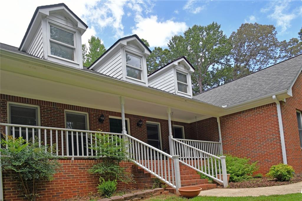 Totally private 1.5 acres and no HOA! This beautiful four-sided brick ranch with side entry garage features a long sweeping driveway with loads of extra parking. Rocking chair front porch overlooks wooded front yard for peaceful enjoyment year-round. Interior features foyer, formal dining room, huge family room with fireplace, four season room, breakfast room, hardwood floors, fantastic kitchen with work station, stained cabinets, expansive counter space, gas cooktop, island breakfast bar and large walk-in pantry. Beautiful screened in porch off the breakfast room that overlooks the huge deck, firepit and plush, private fenced back yard. Owner’s suite features huge walk-in closet, updated and upgraded bath with soaking tub and tiled shower. Spacious secondary bedrooms with ample closets. Walk up permanent staircase to enormous attic with high ceilings – perfect for additional rooms, tons of storage and flooded with light from dormers. The side door enters into an oversized mud room/laundry room. Your outdoor paradise offers extreme privacy, large open yard perfect for recreation or pool, areas for flower and vegetable gardens, fully fenced and storage shed. Oconee Pointe is a beautiful neighborhood, located just minutes to schools, downtown Commerce, shopping, restaurants and easy access to I-85, Athens and outlet shopping.