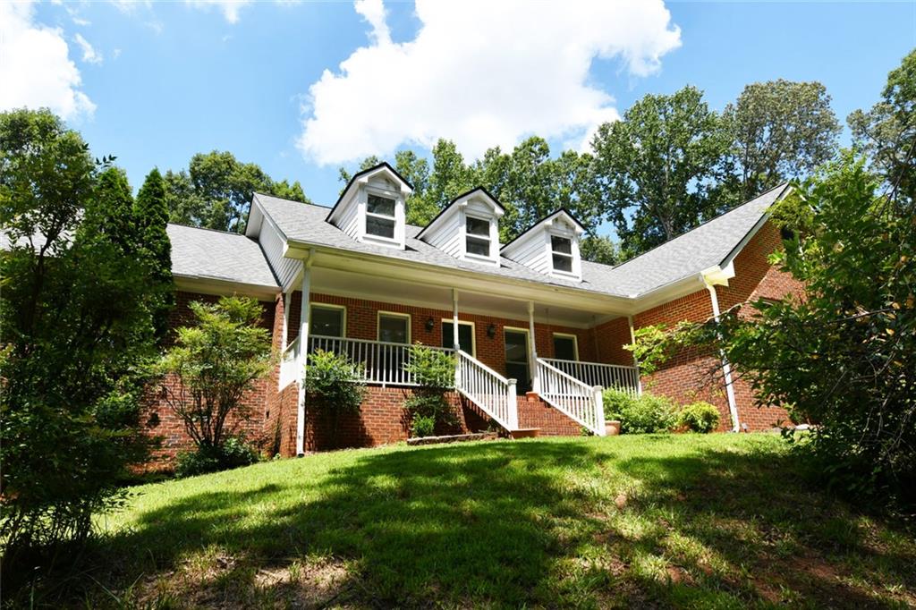 Totally private 1.5 acres and no HOA! This beautiful four-sided brick ranch with side entry garage features a long sweeping driveway with loads of extra parking. Rocking chair front porch overlooks wooded front yard for peaceful enjoyment year-round. Interior features foyer, formal dining room, huge family room with fireplace, four season room, breakfast room, hardwood floors, fantastic kitchen with work station, stained cabinets, expansive counter space, gas cooktop, island breakfast bar and large walk-in pantry. Beautiful screened in porch off the breakfast room that overlooks the huge deck, firepit and plush, private fenced back yard. Owner’s suite features huge walk-in closet, updated and upgraded bath with soaking tub and tiled shower. Spacious secondary bedrooms with ample closets. Walk up permanent staircase to enormous attic with high ceilings – perfect for additional rooms, tons of storage and flooded with light from dormers. The side door enters into an oversized mud room/laundry room. Your outdoor paradise offers extreme privacy, large open yard perfect for recreation or pool, areas for flower and vegetable gardens, fully fenced and storage shed. Oconee Pointe is a beautiful neighborhood, located just minutes to schools, downtown Commerce, shopping, restaurants and easy access to I-85, Athens and outlet shopping.