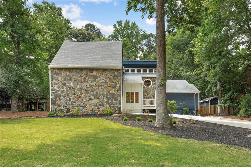 Welcome to 5296 Amhurst Place, a stunningly renovated home nestled in the heart of Peachtree Corners-where timeless craftsmanship meets modern luxury. Every inch of this exceptional residence has been thoughtfully redesigned to offer comfort, elegance, and functionality in one of the area's most sought-after neighborhoods. Whether you're looking for luxury, location, or lifestyle, this home has it all! Home Features: * Dual Master Suites * Enjoy flexibility and luxury with a spacious owner's suite on the main level, perfect for ease of access, and an additional private master retreat upstairs, ideal for guests or multi-generational living. * Spa-Inspired Bathrooms * Featuring curb-less walk-in showers, these bathrooms offer a tranquil, resort-style experience with modern tilework and sleek finishes. * Chef's Kitchen Opens to Large Living Room * Entertain in style with expansive quartz countertops, a large waterfall island, and premium cabinetry. The space is also equipped with Bluetooth-enabled ceiling speakers, making it ideal for casual mornings or lively dinner parties. The heart of the home is the stunning open-concept main level, where vaulted ceilings, solid hardwood floors, and upgraded lighting elevate the space. * Generous Closet Space in Every Room * Function meets form with large closets-a rare and valuable feature in every bedroom. * Outdoor Entertaining Paradise * Step out onto a large, oversized deck overlooking a fully appointed outdoor kitchen, built for entertaining and perfect for Georgia evenings under the stars. * Four-Season Sunroom * A heated and cooled sunroom provides an inviting space to unwind year-round, offering views of the spacious, private backyard. * Unbeatable Location! * Situated just steps from Pinckneyville Middle School , and in award winning Simpson Elementary school district. Close proximity to other top rated schools including Paul Duke Stem, Wesleyan and Cornerstone Christian Academy. In addition, its walking distance to Simpsonwood Park, and only 3 minutes to The Forum and Peachtree Corners Town Center. This completely reenvisioned, rare find is an absolute must-see. Schedule your showing today!