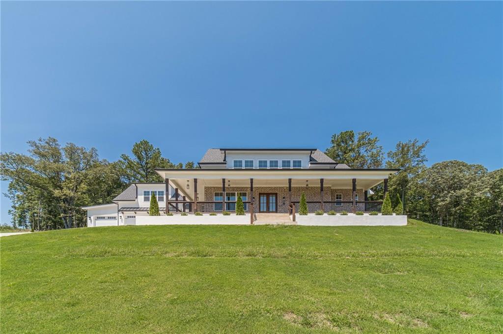 Luxury New Construction Home in Dacula – Over 4,300 Sq. Ft. on 1 Acre! - Welcome to your dream home in the prestigious Hog Mountain community in Dacula, GA! This brand-new construction boasts 5 bedrooms, 4.5 bathrooms, and a spacious 3-car garage—perfect for modern living. Step inside to find solid hardwood floors, elegant lighting fixtures, and a bright, open floor plan. The main-level owner’s suite is a true retreat, featuring two walk-in closets, a spa-like bathroom with a double vanity, a soaking tub, a separate shower, and stunning views. The chef’s kitchen is a showstopper, featuring white cabinets, quartz countertops, stainless steel appliances, a large kitchen island, and a walk-in pantry! - Upstairs, you’ll find additional spacious bedrooms, including a second master suite, plus Bluetooth ceiling fans for added convenience. - Enjoy outdoor living on the front porch or rear porch, surrounded by your 1-acre lot with a long driveway for extra parking. This home truly has it all—modern design, prime location, and plenty of space. Don’t miss out on this rare find!